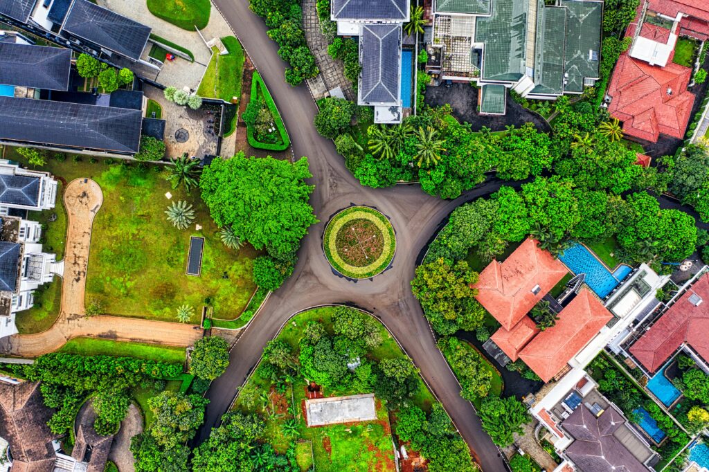 A stunning aerial view of a residential roundabout surrounded by houses and lush greenery in South Jakarta.